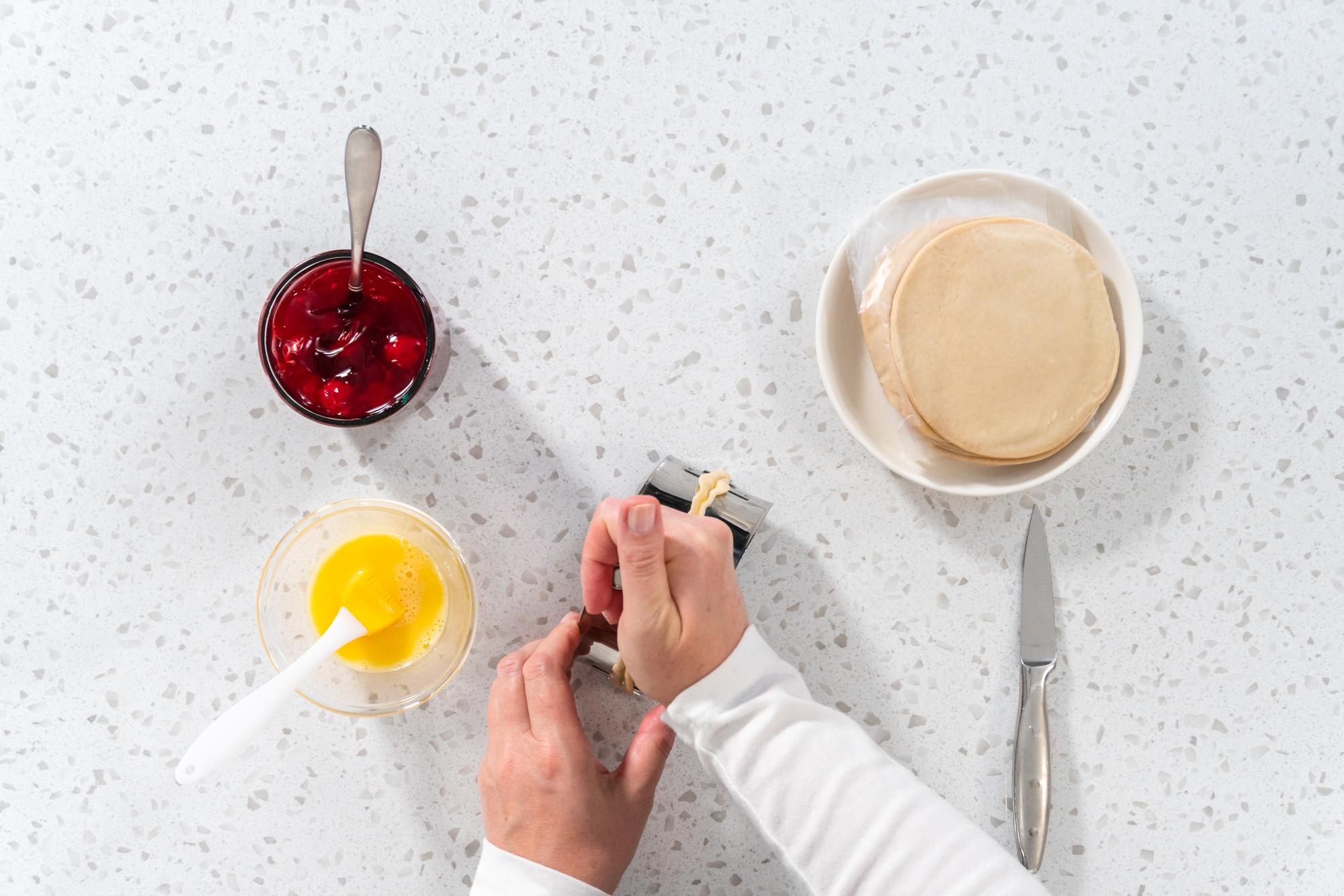 chef tasting sauce at counter